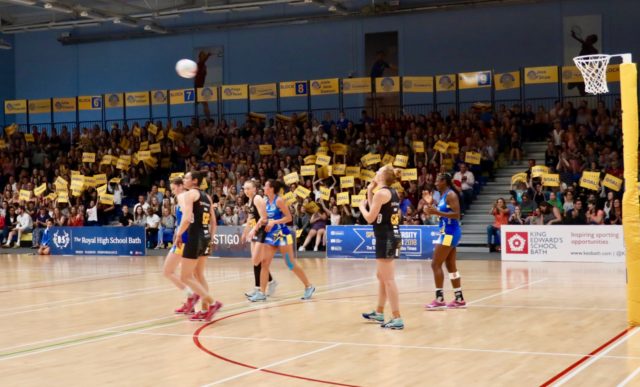 Team Bath Netball fans wave their goal cards during the sell-out match against Wasps, June 2018