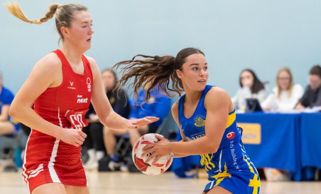 A picture of Team Bath Netball wing-attack Sienna Rutherford with the ball in hand, turning away from a Nottingham Forest defender during the first-ever NXT Gen League fixture in February 2025.