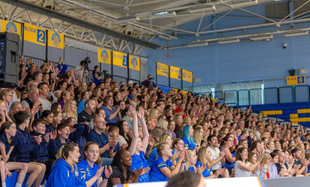 A stand full of Team Bath Netball fans celebrating.