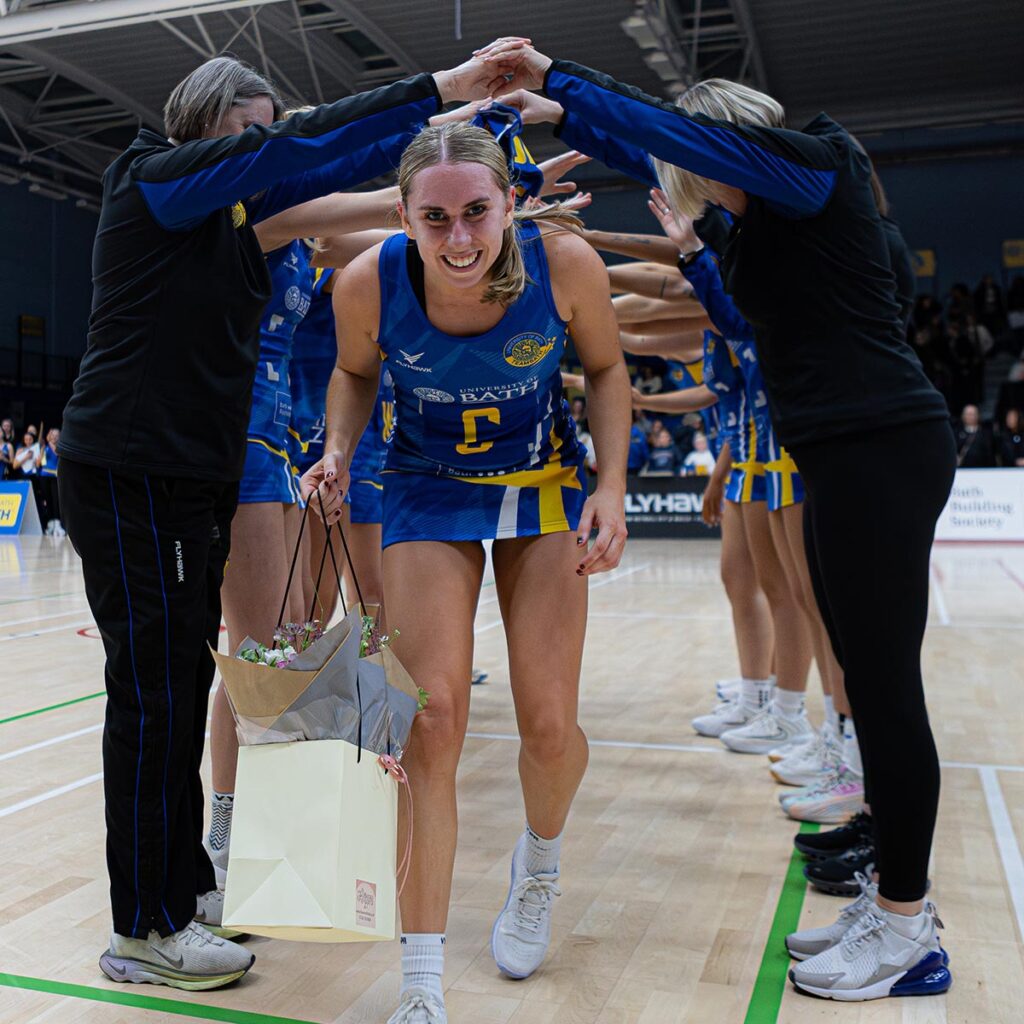 Most Valuable Player Lucy Button smiles at the camera as she walks through a guard of honour