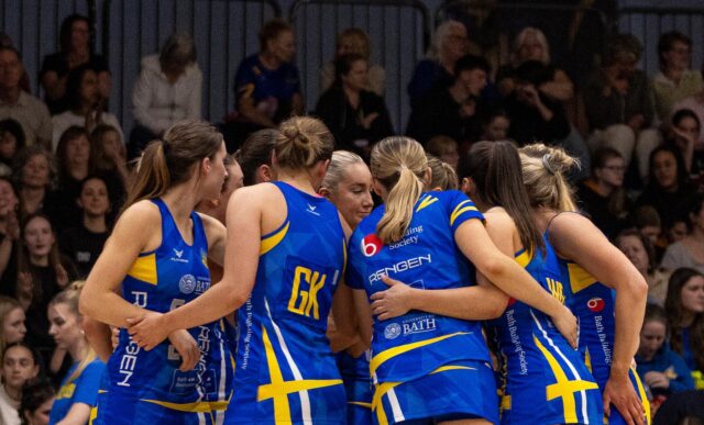 Team Bath Netball players huddle in front of their home crowd before a NXT Gen League match