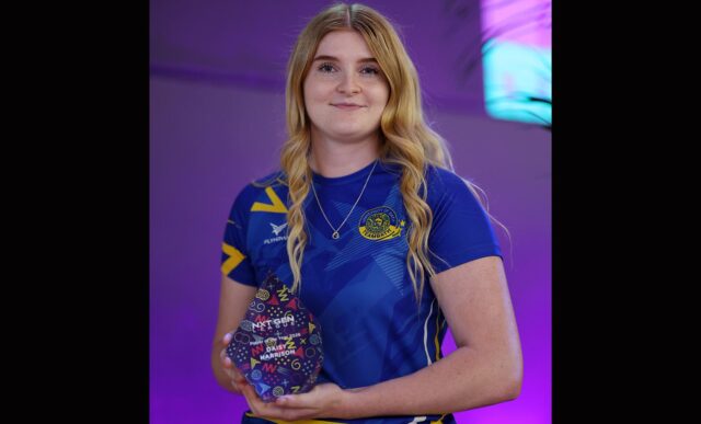 Daisy Harrison, wearing a Team Bath Netball training top, holding the NXT Gen League Player of the Season trophy for 2026